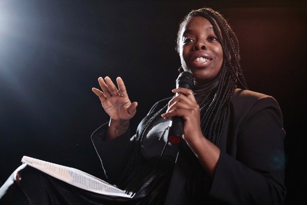Woman Speaking Into Microphone Confidently