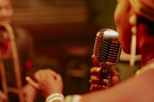 Woman Singing Into Vintage Microphone